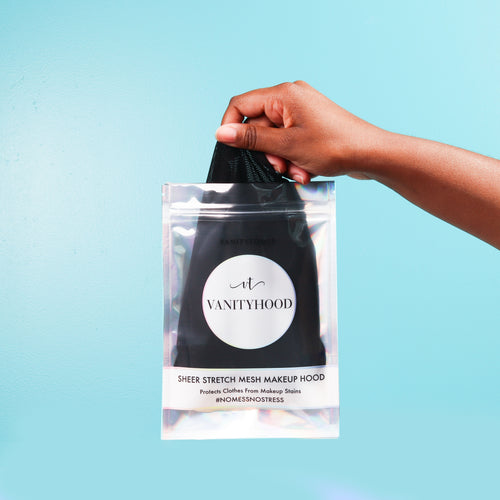 A person holding a VanityHood makeup protector hood